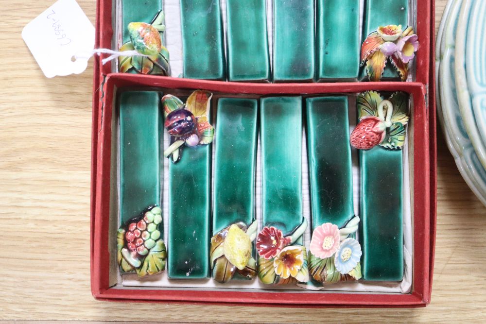 A set of six French earthenware plates, faience plates etc and pottery knife rests